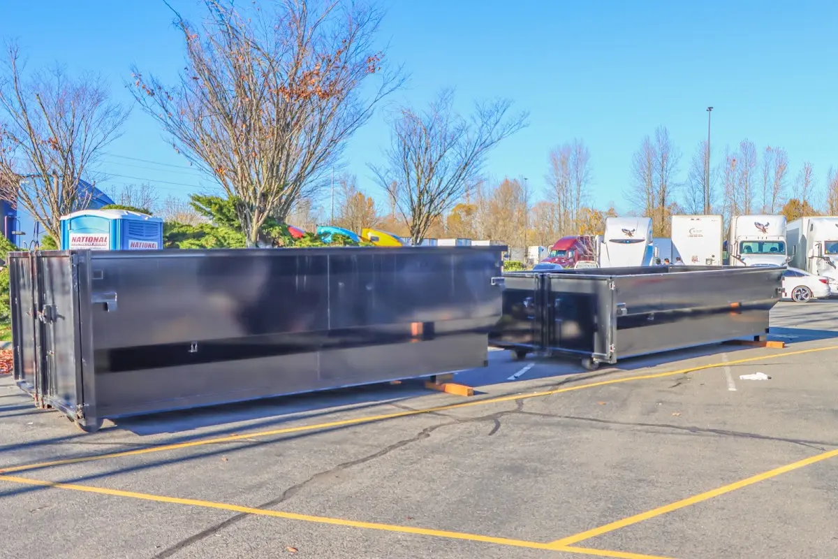 Professional dumpster rental service with roll-off container on residential driveway in Joshua